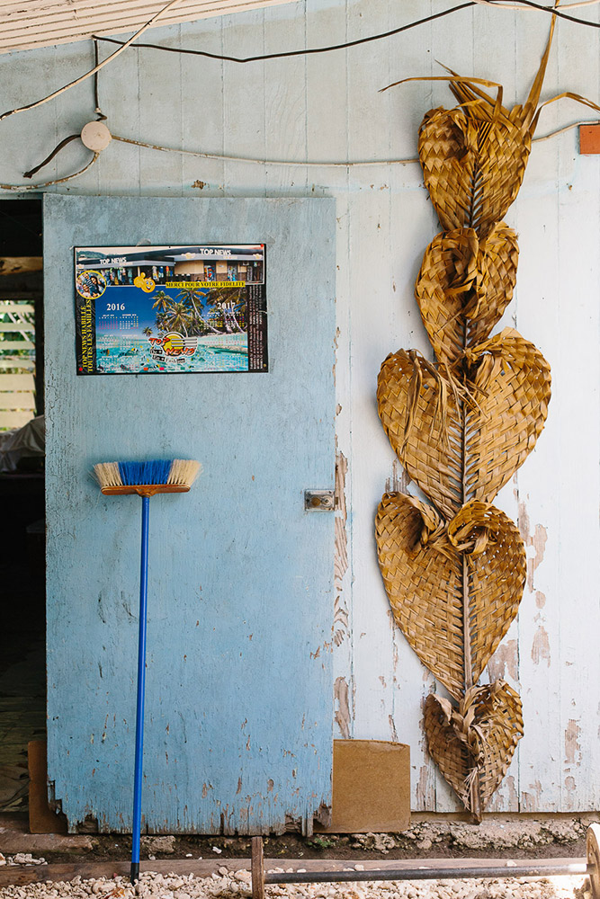 Traditional weaving hangs at the door of someones home in Huahine