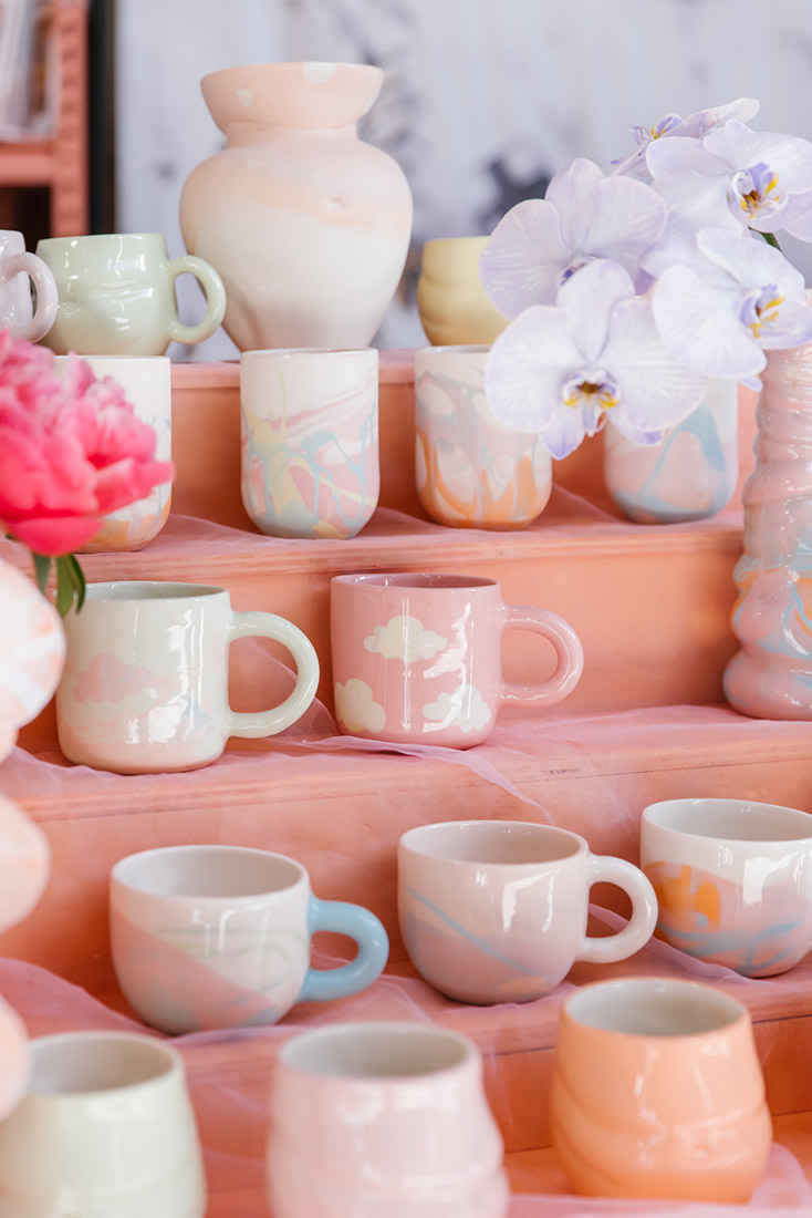 Pastel peach and pink mugs on display by Voluptuary Ceramics, Sydney
