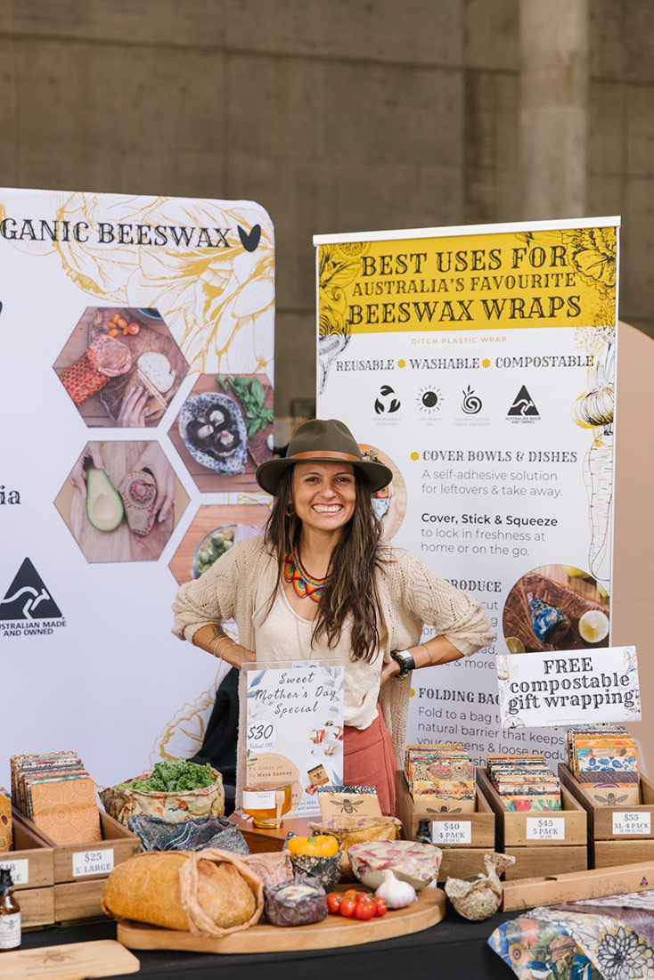 Portrait of a woman in front of her market stall selling organic beeswax wraps