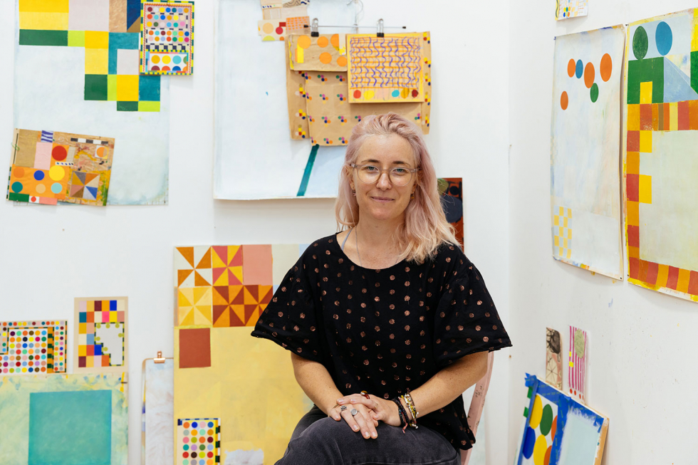 Portrait of Sydney artist Emily Besser surrounded by works in progress in her studio
