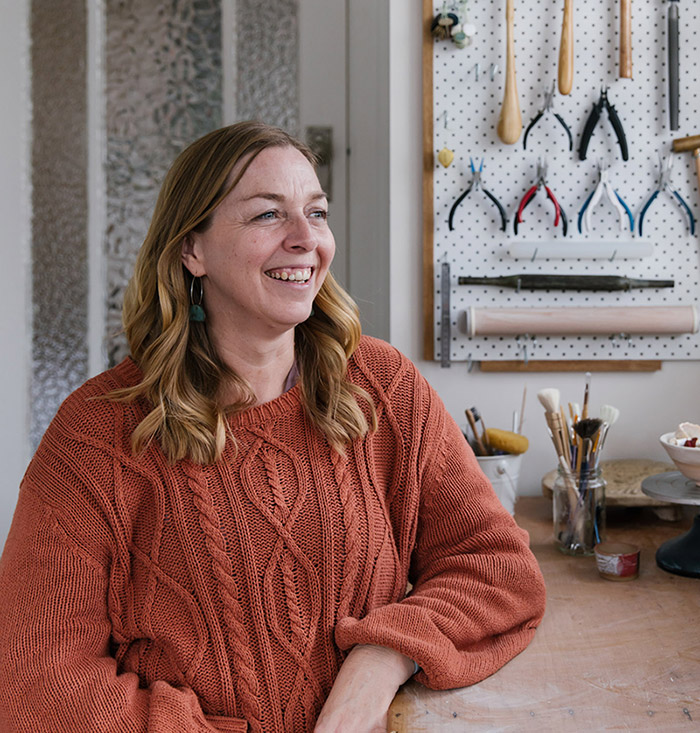 Maker Nicole Redenbach smiles candidly in her home studio of Meraki Fire Ceramics Sydney