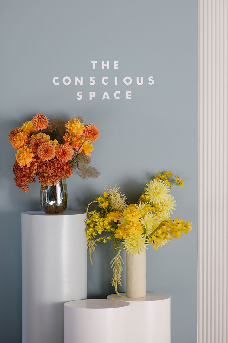 The Conscious Space event styling with vases of bright fresh flowers