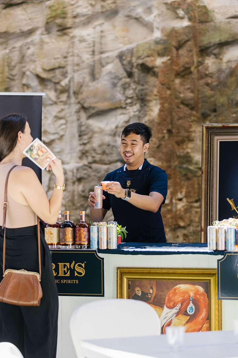 A barman serves a customer a brand of non-alcoholic liquour at The Conscious Space Sydney event
