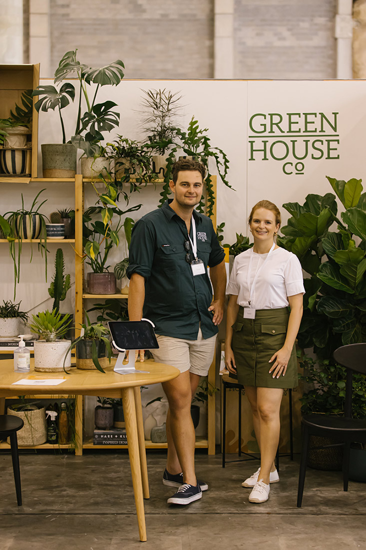 The duo behind Green House Co in front of their stand of plants and greenery for the home