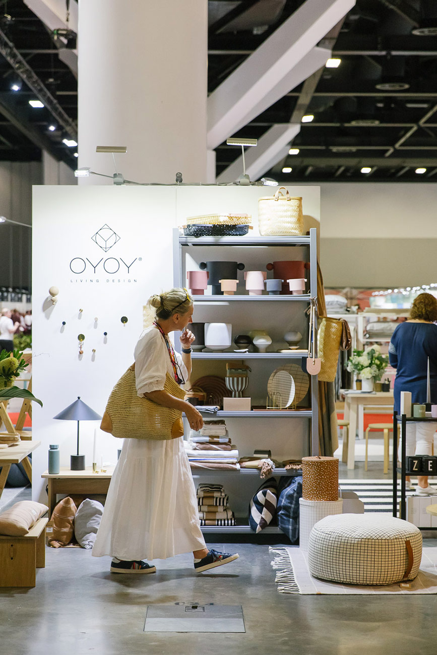 An attendee at a trade show browses homewares products to source for their store