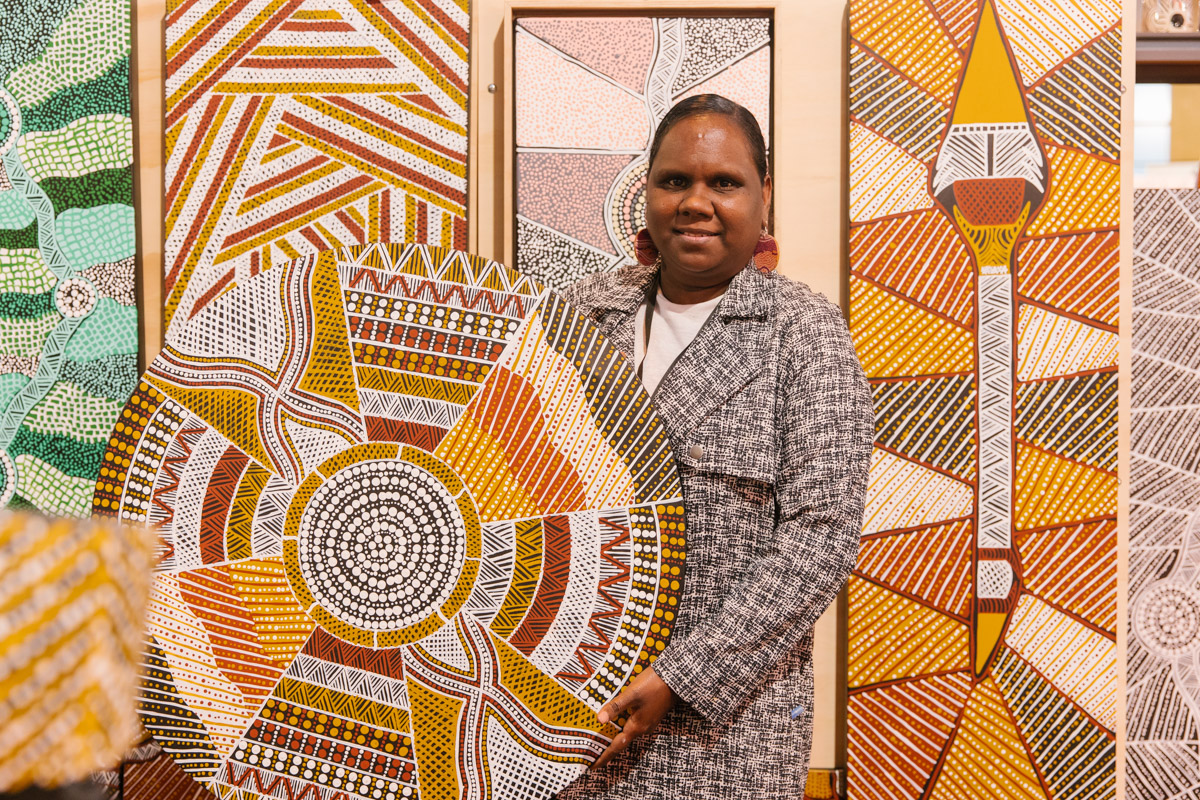 First Nations Tiwi artist Russellina Puruntatameri poses for a portrait with their work at The Finders Keepers Market Melbourne