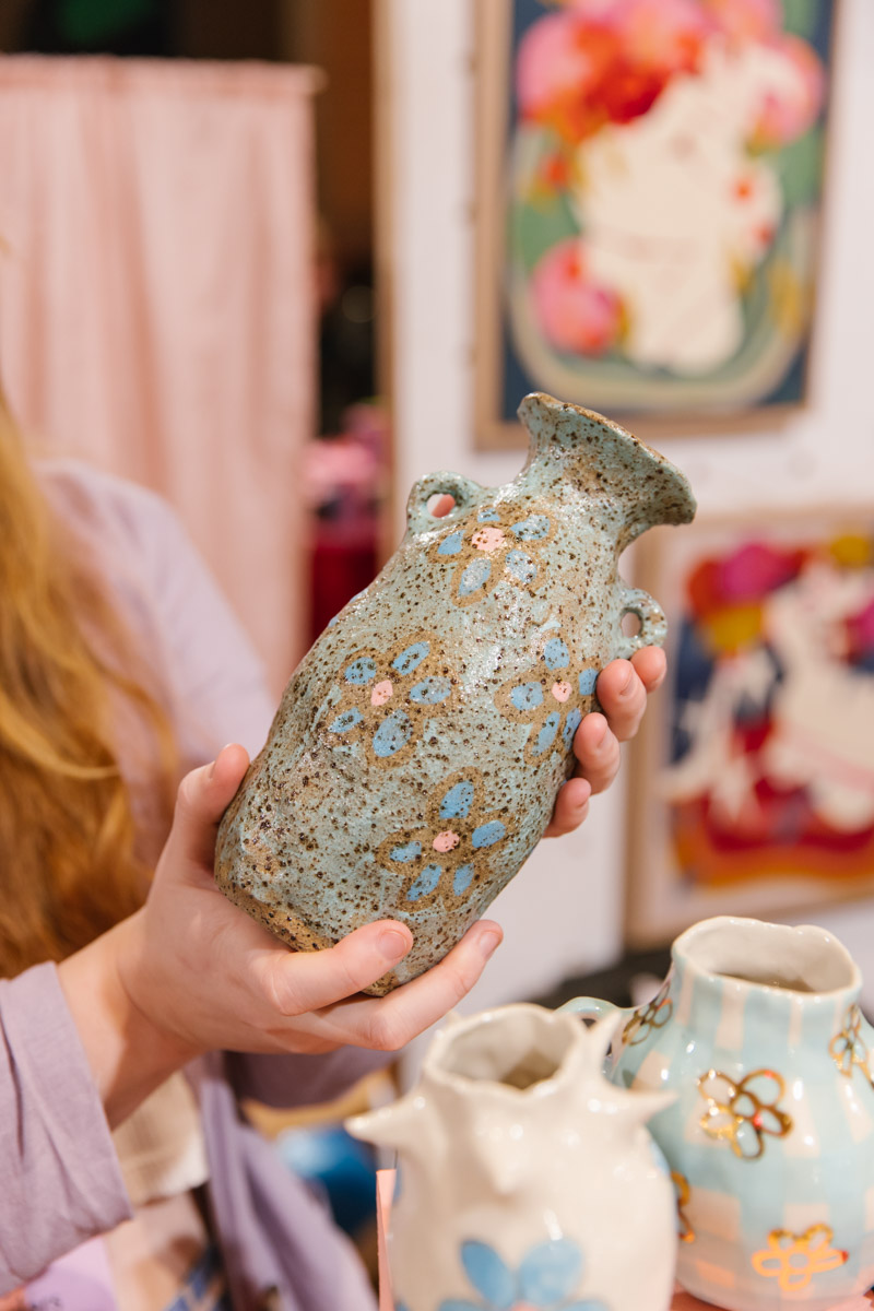 Handmade ceramic vase held in the hands of the maker