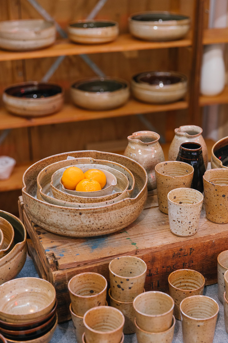 Earthy ceramic bowls and cups on display
