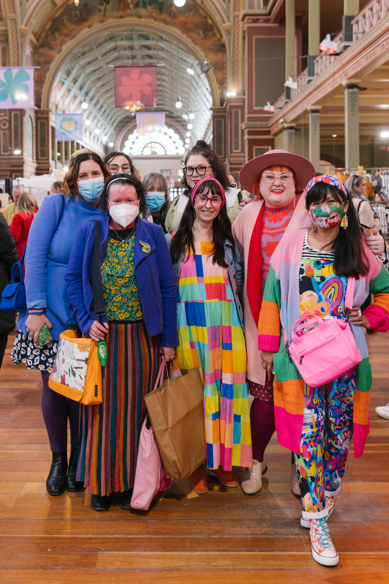 Group of friends stand together for a photo in bright colourful outfits at The Finders Keepers Market Melbourne