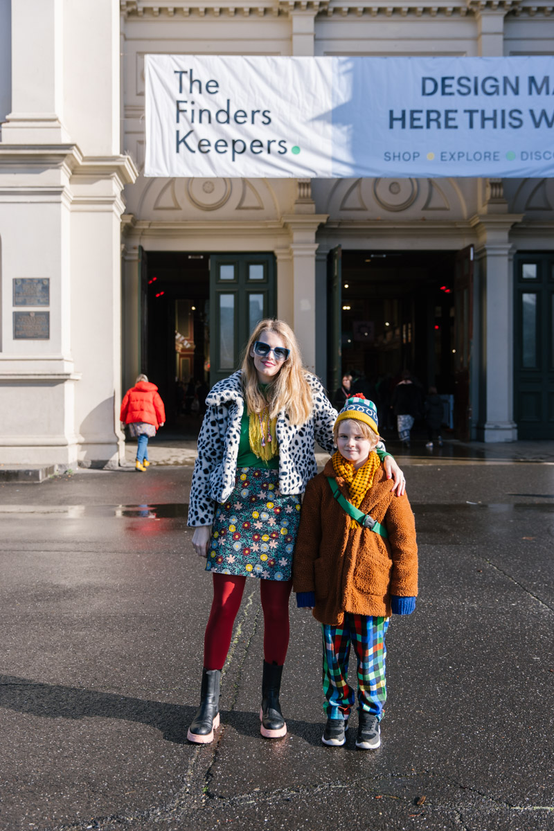 Mum and child stand for a photo in front of the Royal Exhibition Building for The Finders Keepers Market