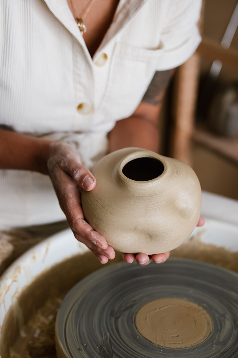 Ciane of Glost Studios forms a wheel thrown vase complete with her signature dimple marks