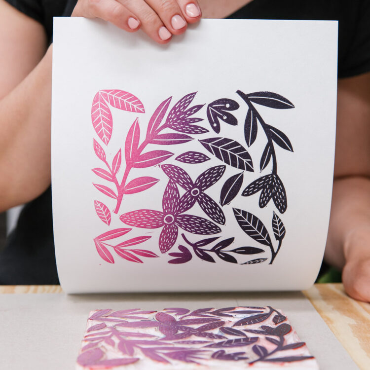 Block Printing artwork is pulled from a hand carved rubber block to reveal a gradient of pink to purple floral artwork