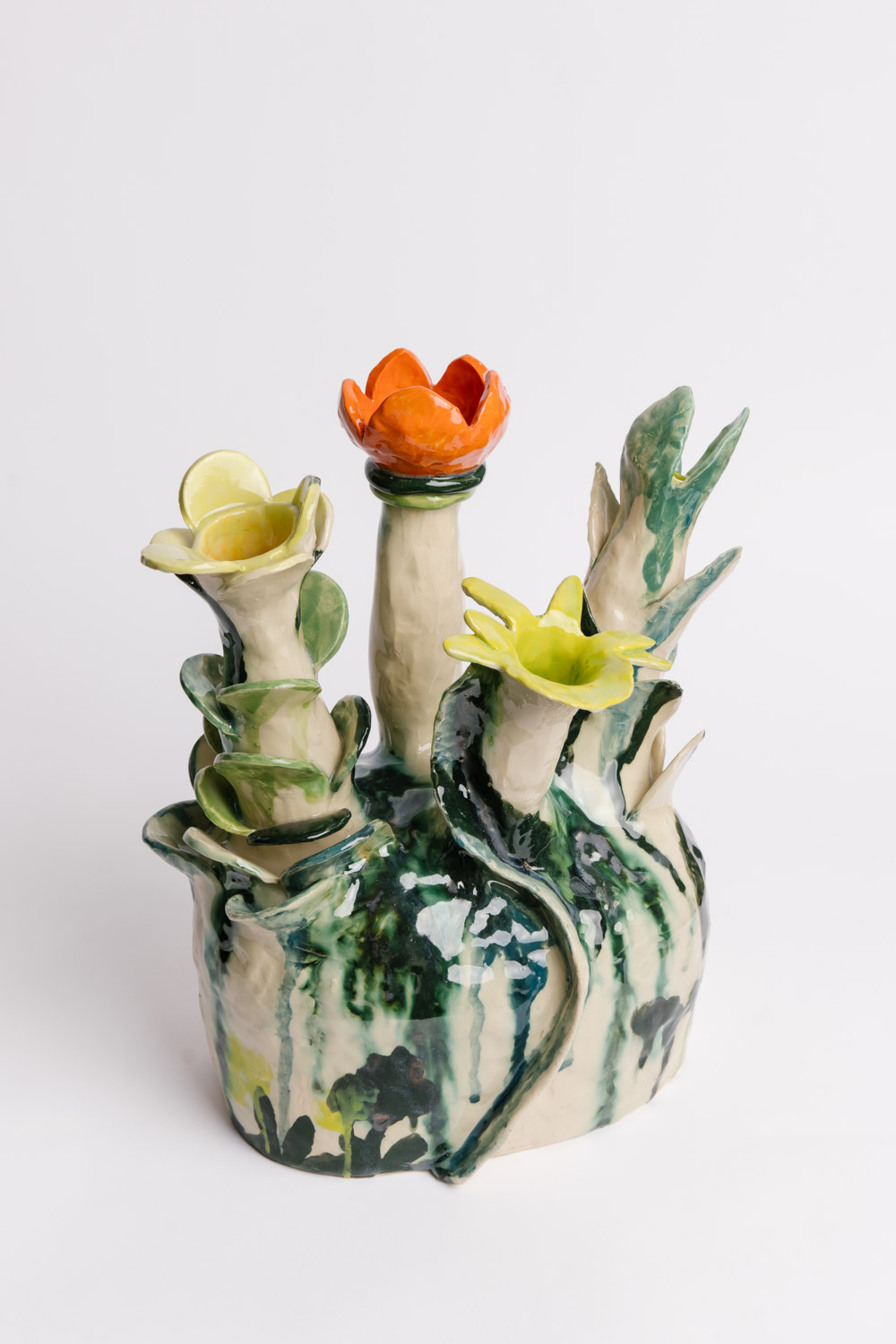 Ceramic sculptural work by Susan Buret, featuring flowers in yellow and orange, photo by Samee Lapham