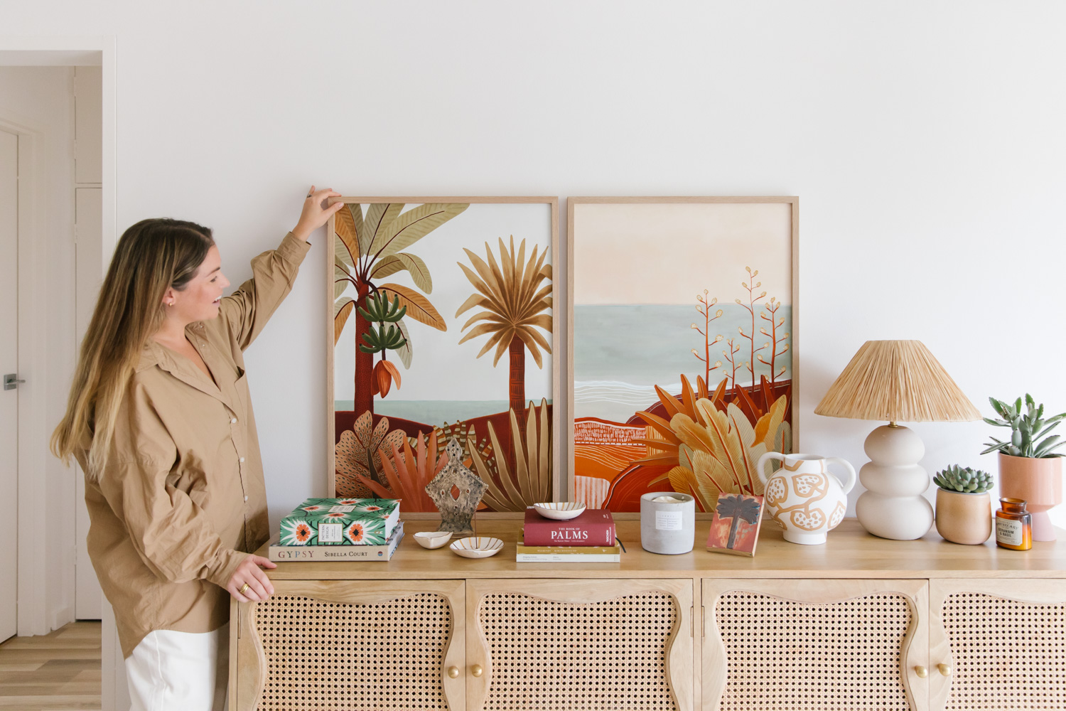 Framed fine art prints by artist Karina Jambrak styled on a wooden buffet, photo by Samee Lapham