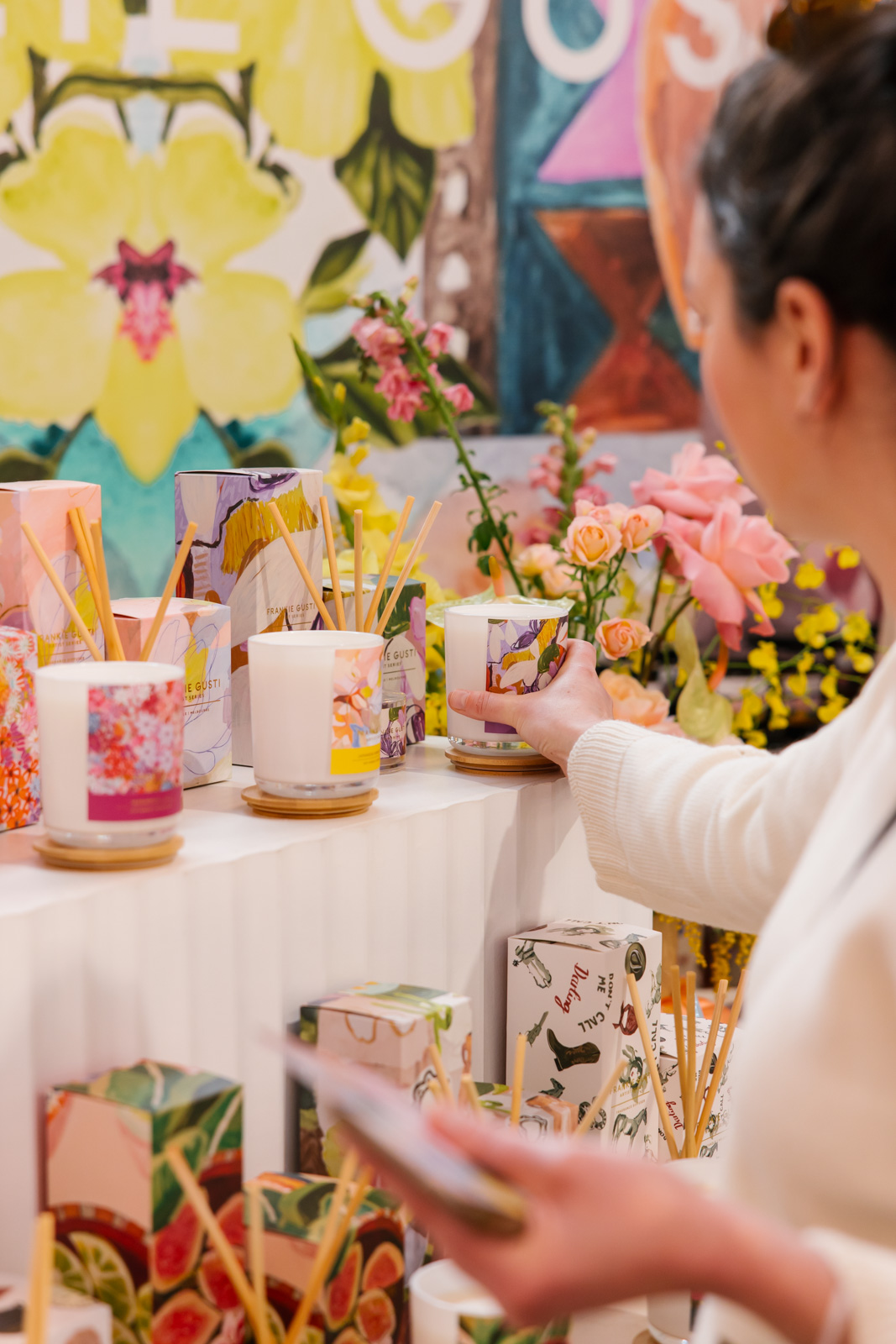 Customer reaching to smell a candle